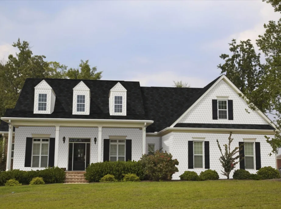 Cape Cod style home after visualization - clean white siding with black accents