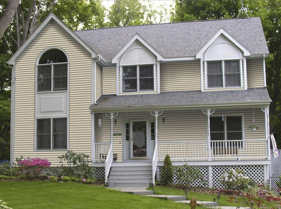 Traditional home before siding visualization - pale yellow with white trim